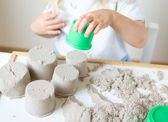 Little Caucasian Girl Playing with Kinetic Sand at Home Early Education Preparing for School...