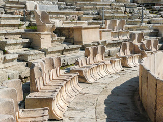 The Theatre of Dionysus Eleuthereus of the Athenian Acropolis. Athens, Greece. Ancient greek amphitheater. old ruins, spectators' or VIPs seats at the first rows
