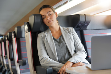Businesswoman sleeping on train