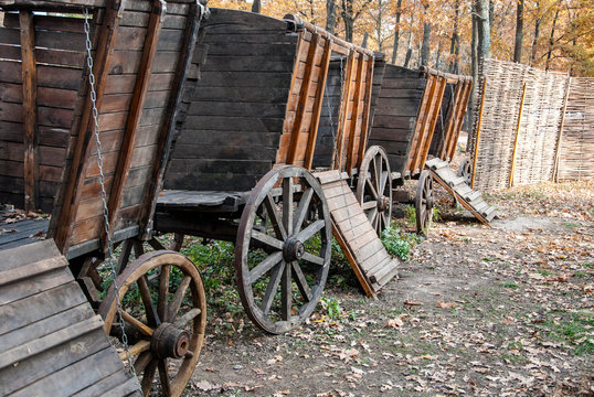 Old horse drawn wooden cart. Convoy of several carts in the autumn forest