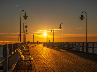 Beautiful and amazing sunrise on the pier at the seaside, Gdynia, Poland.