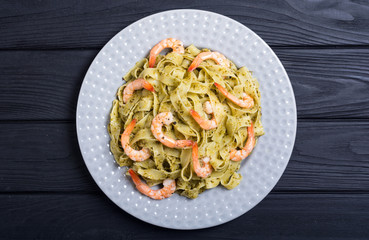 Pasta tagliatelle with sauce pesto and shrimps