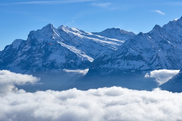 Mountain peak over clouds in the valley. Jungfrau region in Switzerland.