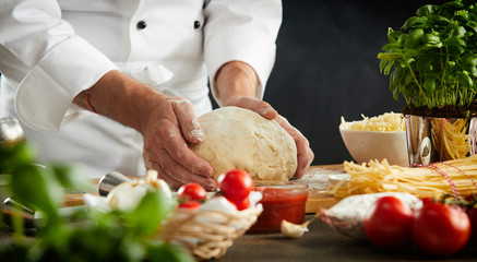 Chef kneading dough for pizza and pasta
