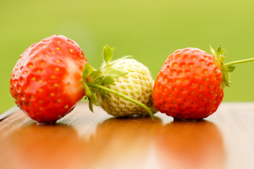 White and red strawberries lie in the sun. Delicious and sweet dessert berry. Vitamins