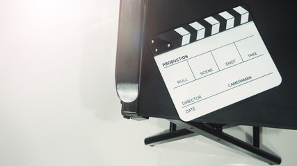 Clapper board or clap board or movie slate with black director chair use in video production ,film...
