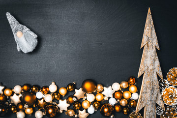 Flatlay of christmas concept with baubles and dwarf and blank space in front of black background