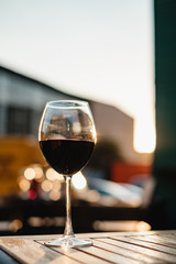 Still life shot of glass with red wine at sunset