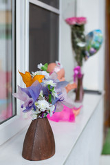 A small vase of flowers on the windowsill