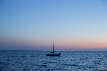Fototapeta premium Sailing yacht at sea at sunset