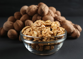 bowl of walnut kernels on a dark background