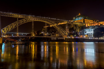 Fototapeta na wymiar Night landscape of the city of Porto on the Douro River, overlooking the bridge of San Luis and the monastery.