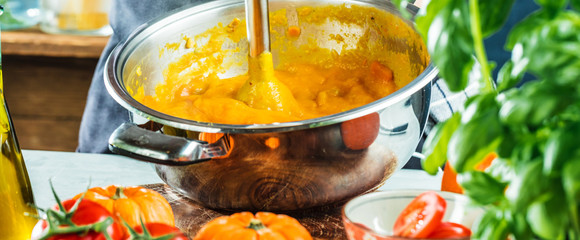 Chef with blender make Pumpkin soup in Kitchen