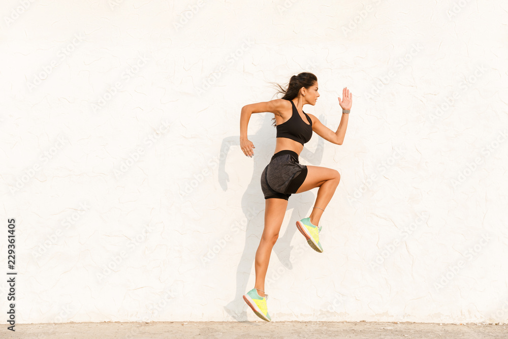 Sticker Pretty young sportswoman doing stretching exercises