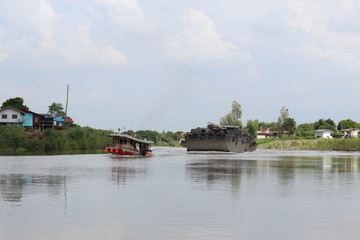 Fototapeta na wymiar The ship is towed on the river.