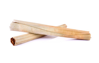Tobacco pile and cigarette on white