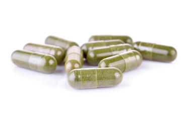 Moringa capsule pills on white background