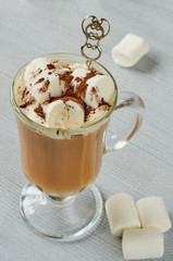 Healthy winter Christmas cocktail - hot cocoa drink with marshmallows and chocolate powder in the glass on the gray concrete background