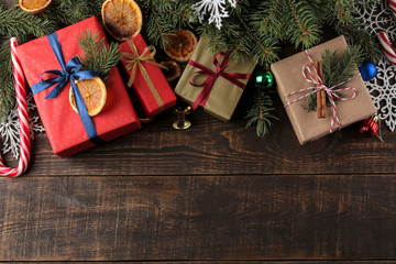 Fototapeta na wymiar New Year. Christmas. Holidays. Composition with new year and christmas gifts on brown wooden background. view from above
