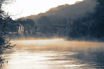 River Severn running through the Ironbridge Gorge with the Ironbridge in the background on a misty morning