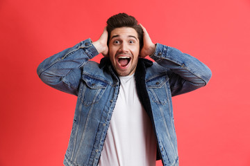 Portrait of an excited young man dressed in denim jacket