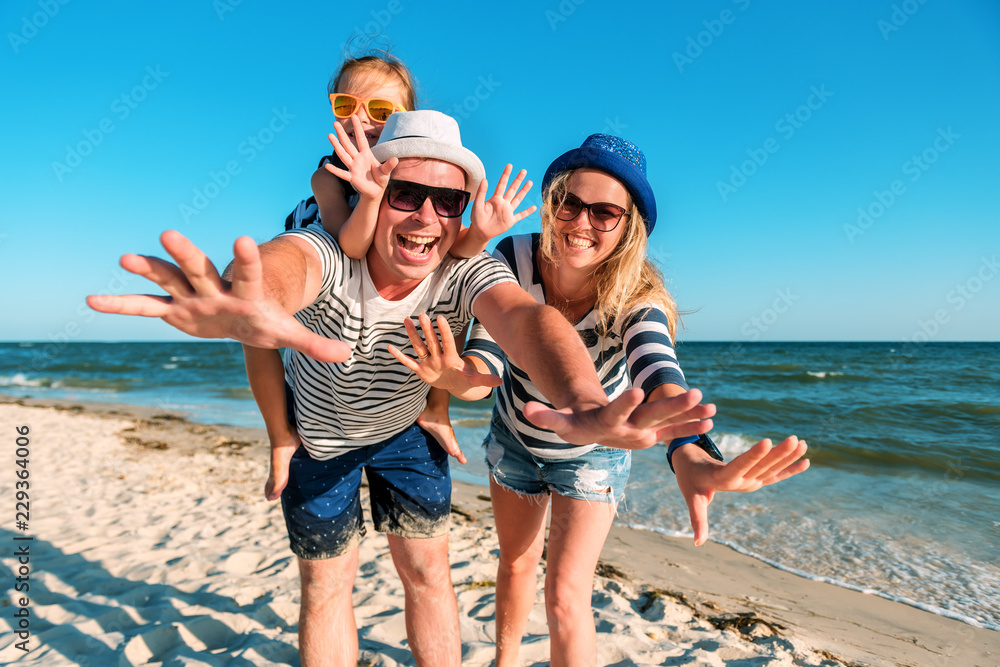 Wall mural funny happy family on the beach