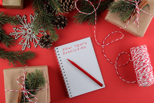 New Year. Christmas. Holidays. Composition with New Year and Christmas gifts and the New Year's resolution form. View from above