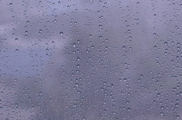 Fototapeta premium Rain drop on glass window set as background photo.