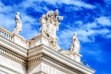 Fototapeta na wymiar Statues on the Basilica of St. Peter against the blue sky. Vatican 