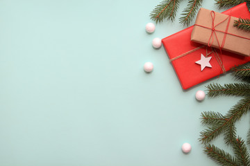 Christmas background. Composition with Christmas gift boxes, fir tree branches and decorations on blue background. Top view with copy space.