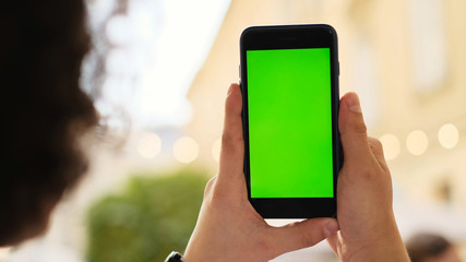 young man using his mobile phone in city. Close up of a man usin