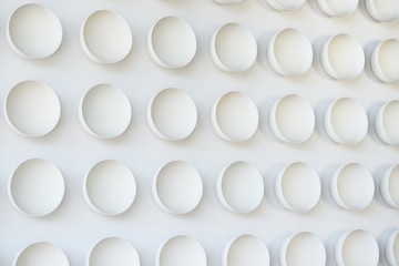 lots of white round plates or cups on white background - texture or background.