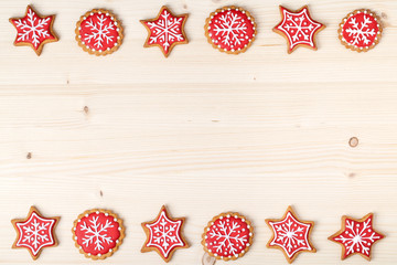 christmas homemade gingerbread cookies on wooden background with empty copy space for text. snowflake and star shapes. holiday, celebration and cooking concept. new year and christmas frame
