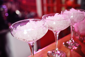 glasses of cocktails with ice close up on the background of the bar