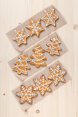 homemade christmas gingerbread cookies on wooden background top view. snowflake, star, christmas tree shapes. holiday, celebration and cooking concept. new year and christmas postcard