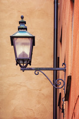 An old street lamp on the wall of a house in Stockholm