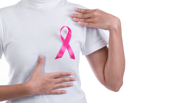 Woman in white t-shirt with pink ribbon on chest. supporting symbol of breast cancer awareness and international women day campaign.