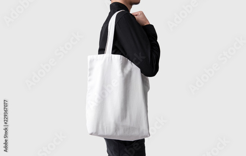 Man Is Holding Bag Canvas Fabric For Mockup Blank Template Isolated Man Is Holding Bag Canvas Fabric For Mockup Blank Template Isolated On Gray Background