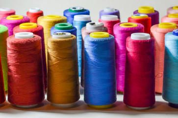 Spools of colours threads isolated on white background