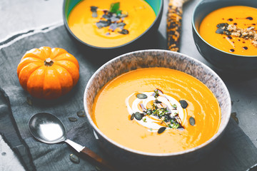 Roasted pumpkin and carrot soup with cream and pumpkin seeds 