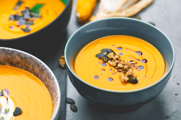 Roasted pumpkin and carrot soup with cream and pumpkin seeds 