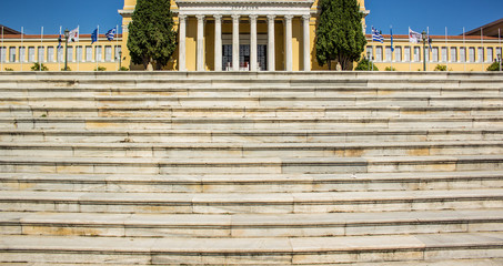 Fototapeta premium symmetry Greece marble palace front facade on blue sky background and stairs foreground