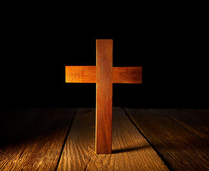 Naklejka premium Christian wood cross on black background