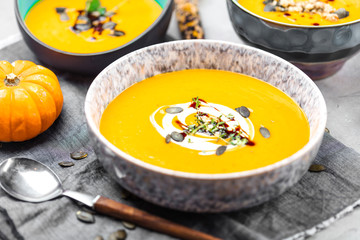 Roasted pumpkin and carrot soup with cream and pumpkin seeds 