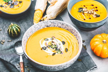 Roasted pumpkin and carrot soup with cream and pumpkin seeds 