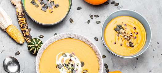 Roasted pumpkin and carrot soup with cream and pumpkin seeds 