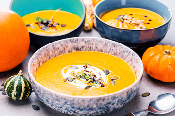 Roasted pumpkin and carrot soup with cream and pumpkin seeds 