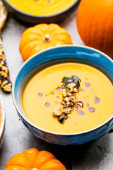 Roasted pumpkin and carrot soup with cream and pumpkin seeds 