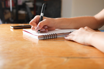 Woman writes in notebook