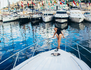 Young beautiful girl staying on front on yacht - 229373466